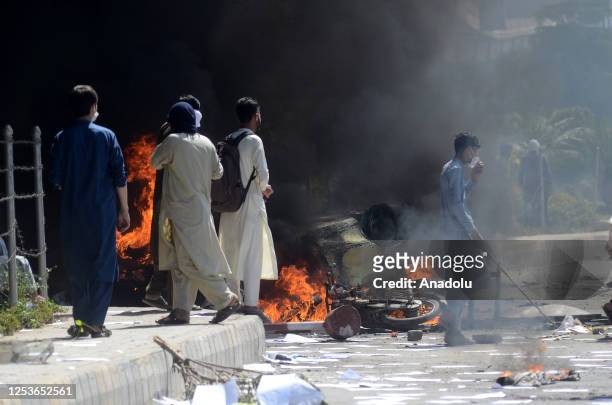 Pakistan Tehreek-e-Insaf party activists and supporters of former Pakistan's Prime Minister Imran Khan, clash with police during a protest against...