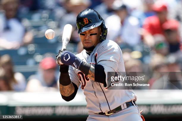 Javier Baez of the Detroit Tigers reacts after getting hit by a pitch from Enyel De Los Santos of the Cleveland Guardians during the seventh inning...