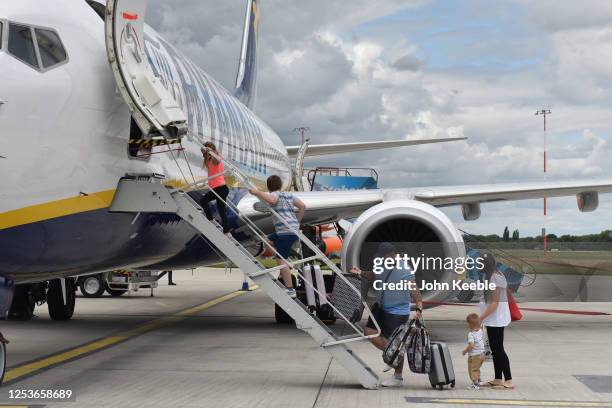 Family board Ryanair flight FR2190 to Malaga at London Southend Airport on July 1, 2020 in Southend-on-Sea, England. The airport opened its doors...