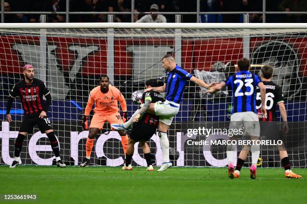 Inter Milan's Bosnian forward Edin Dzeko shoots to open the scoring during the UEFA Champions League semi-final first leg football match between AC...