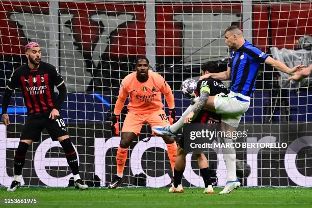 Inter Milan's Bosnian forward Edin Dzeko shoots to open the scoring during the UEFA Champions League semi-final first leg football match between AC...