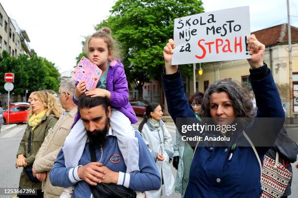 People hold banners which is written as "Nis against violence" to take attention of school attack happened in the country, during the demonstration...