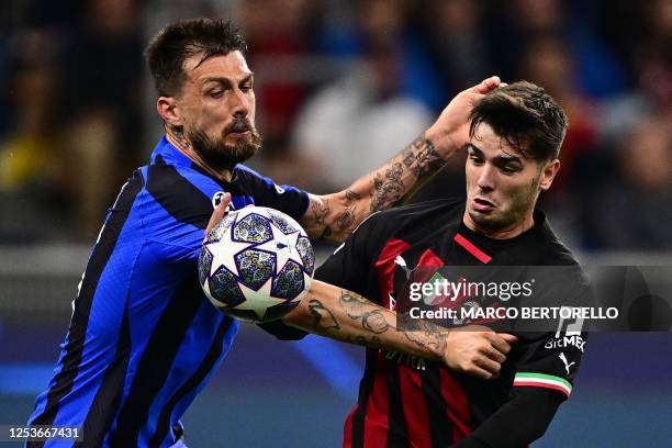 Inter Milan's Italian defender Francesco Acerbi and AC Milan's Spanish midfielder Brahim Diaz go for the ball during the UEFA Champions League...