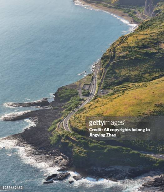 overlook the winding road along coast of reunion island - la reunion stock-fotos und bilder
