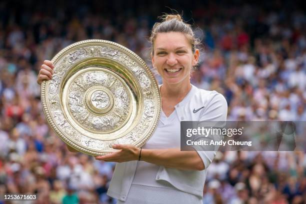 Simona Halep of Romania poses with trophy after winning Championship point in her Ladies Singles final against Serena Williams of USA during Day...