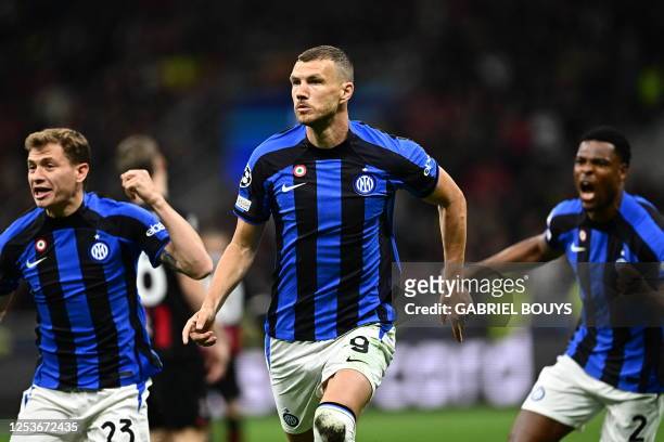 Inter Milan's Bosnian forward Edin Dzeko reacts after opening the scoring during the UEFA Champions League semi-final first leg football match...