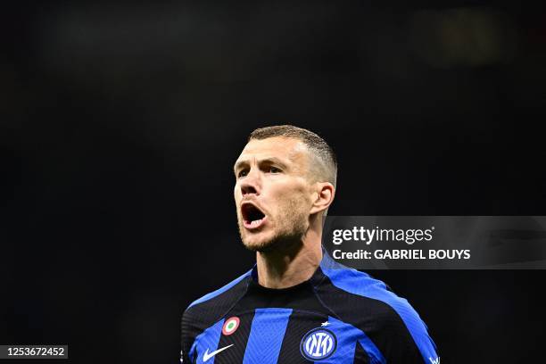 Inter Milan's Bosnian forward Edin Dzeko celebrates after opening the scoring during the UEFA Champions League semi-final first leg football match...