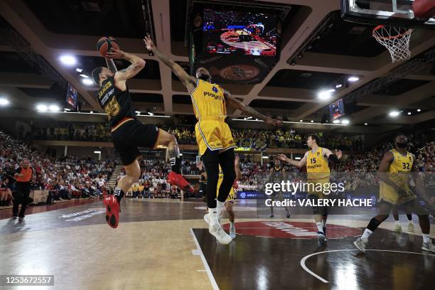 Monaco's US guard Mike James jumps to take a shot as Maccabi's Spanish point guard Lorenzo Brown tries to block it during the Euroleague quarter...