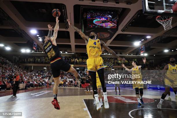 Monaco's US guard Mike James jumps to take a shot as Maccabi's Spanish point guard Lorenzo Brown tries to block it during the Euroleague quarter...