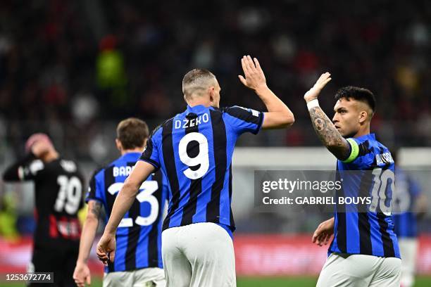Inter Milan's Bosnian forward Edin Dzeko celebrates with Inter Milan's Argentinian forward Lautaro Martinez after opening the scoring during the UEFA...