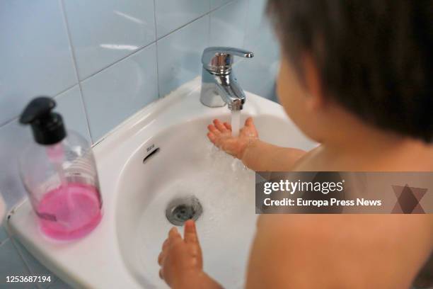 Child is seen washing his hands at Gloria Fuertes Nursery School, on the day of its reopening after the break due to the coronavirus at the town of...