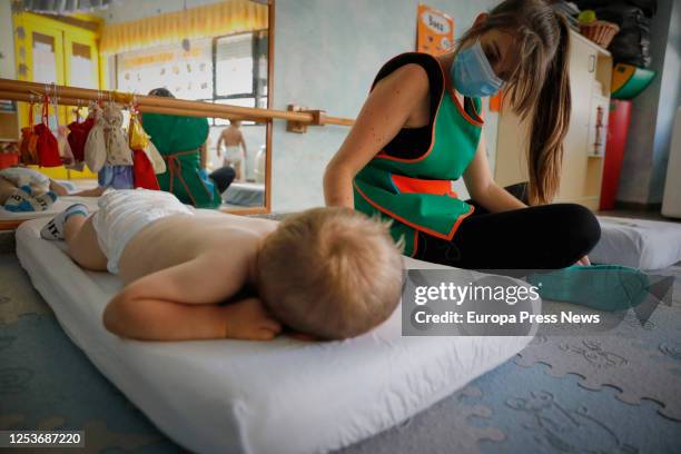 Child is seen preparing to rest at the Gloria Fuertes Nursery School, on the day of its reopening after the break due to the coronavirus at the town...