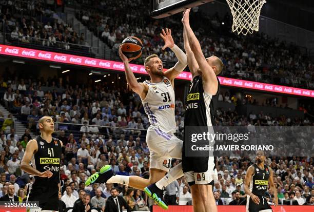 Partizan Belgrade's Serbian forward Alen Smailagic blocks a shot attempt by Real Madrid's Bosnian forward Dzanan Musa during the Euroleague quarter...