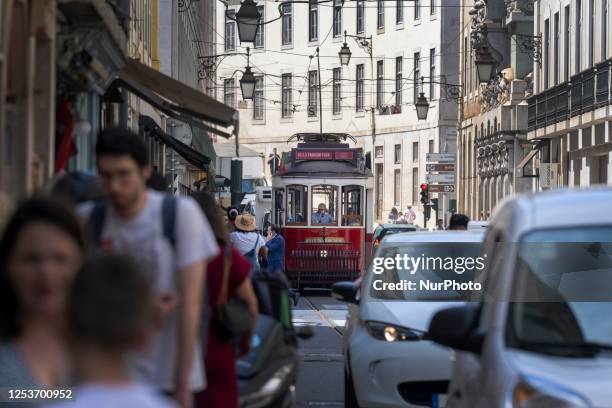 Trams are seen passing through one of the streets in the neighborhood of Baixa, Lisbon. 02 May 2023.