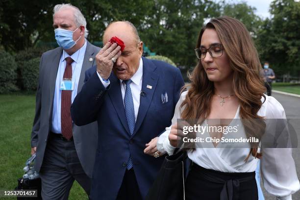 Accompanied by his communications director Christianne Allen , President Donald Trump's lawyer and former New York City Mayor Rudy Giuliani wipes...