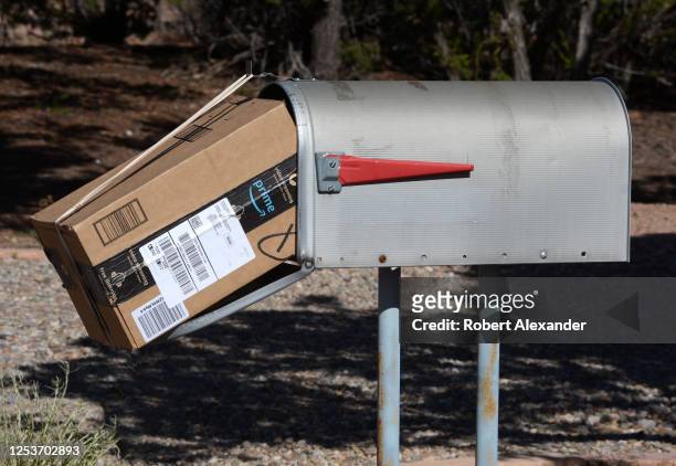 An Amazon Prime package delivered to a mailbox by a U.S. Postal Service mailman in Santa Fe, New Mexico.