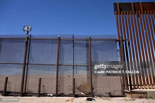 Hole is seen in a gate along the border wall where migrants are believed to have crossed through on the US-Mexico border in El Paso, Texas, on May...