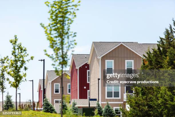 row of bright multi-colored homes on a sunny summer day - midwest stock pictures, royalty-free photos & images