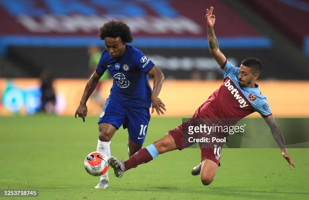 Manuel Lanzini of West Ham United tackles Willian of Chelsea during the Premier League match between West Ham United and Chelsea FC at London Stadium...