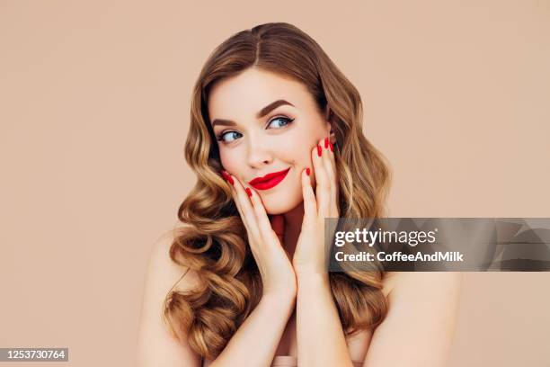 portrait of young and beautiful woman with long hair - apply lipstick stock pictures, royalty-free photos & images