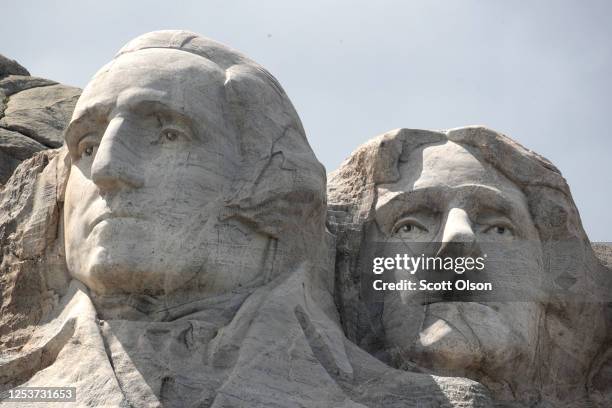 The busts of U.S. Presidents George Washington, and Thomas Jefferson tower over the Black Hills at Mount Rushmore National Monument on July 01, 2020...