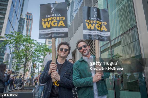 Actors Adam Scott and Nick Kroll seen marching in solidarity with the WGA. The 2023 Writers Guild of America strike is an ongoing labor dispute...