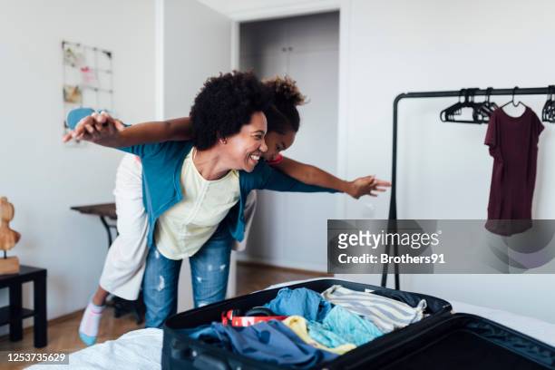 an african american family getting ready for a vacation - packing suitcase stock pictures, royalty-free photos & images