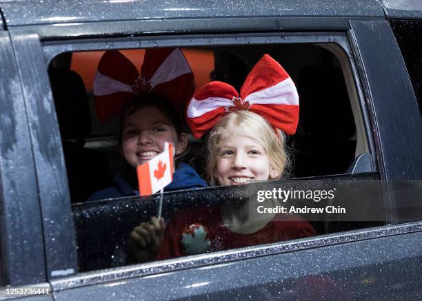 Attendees drive through a "reverse" Canada Day parade at PNE on July 01, 2020 in Vancouver, British Columbia. The Canada Day parade was organized as...