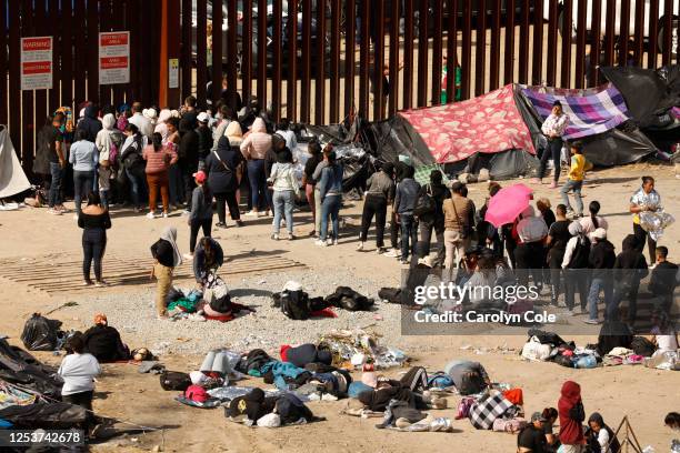 Tijuana, MexicoMay 10, 2023Migrants hoping to cross into the United States from Tijuana, Mexico, wait in an area south of the second border wall in...