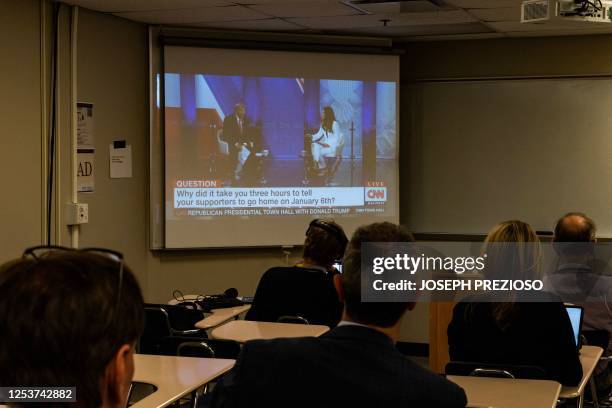 Reporters watch a CNN town hall with former US President and 2024 Presidential hopeful Donald Trump at St. Anselm College in Manchester, New...