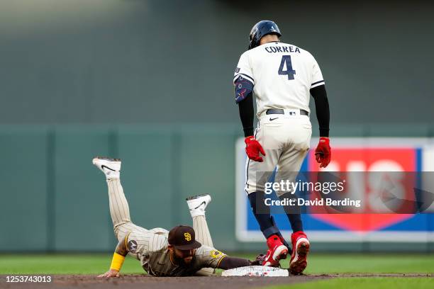 Carlos Correa of the Minnesota Twins is safe at second base on his RBI double as Rougned Odor of the San Diego Padres fields the ball in the third...