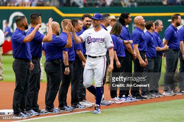 Bullpen coach Brett Hayes of the Texas Rangers greets teammates prior to the game between the Philadelphia Phillies and the Texas Rangers at Globe...