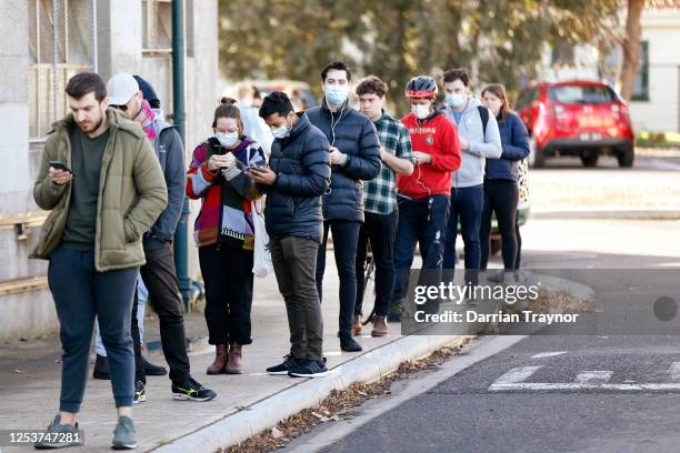 Members of the public line up outside a walk in COVID testing clinic in Brunswick on July 02, 2020 in Melbourne, Australia. The clinic was set up by...