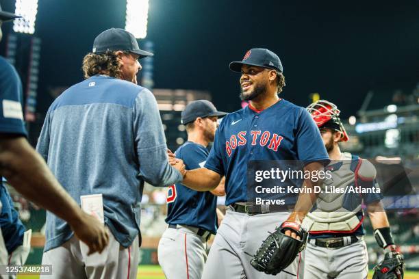 Kenley Jansen of the Boston Red Sox celebrates his 400th career save with Andy Fox in a 5-2 win over the Braves at Truist Park on May 10, 2023 in...