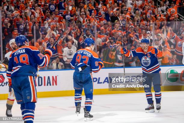 Ryan Nugent-Hopkins of the Edmonton Oilers celebrates his second period goal against the Vegas Golden Knights with Connor McDavid and Zach Hyman in...