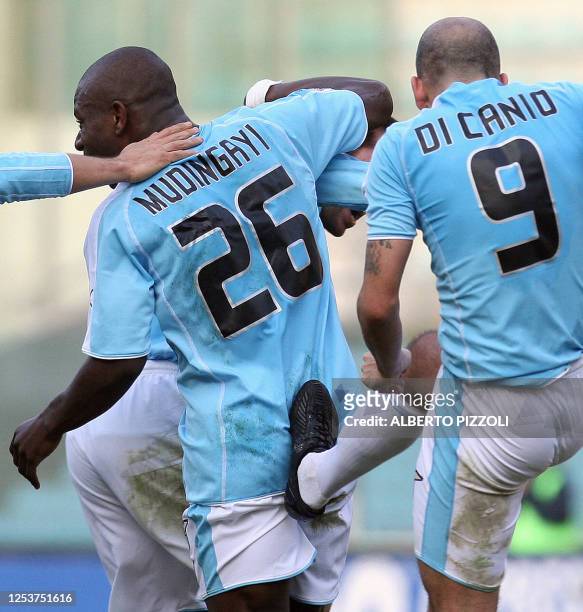 Lazio Roma's Gaby Mudingayi of Congo recieves a kick in the back from his teammate Paolo Di Canio after scoring against FC Ascoli during Italian...