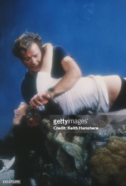 English actor Roger Moore as 007 with French actress Carole Bouquet as Melina Havelock on the set of the James Bond film 'For Your Eyes Only', 1981....