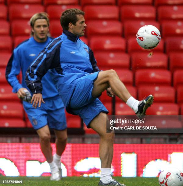 England football player Michael Owen volleys a ball as player David Beckham looks on during training at Old Trafford football grounds, Manchester, 07...