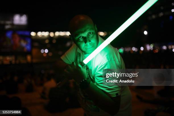 Man is seen playing with lightsaber as they watch Star Wars Movie at Medellin, Colombia on May 4, 2023. During the last years Medellin had a...