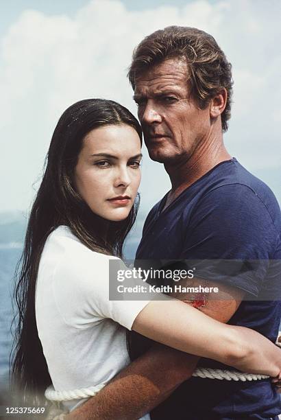 English actor Roger Moore as 007 with French actress Carole Bouquet as Melina Havelock on the set of the James Bond film 'For Your Eyes Only', March...