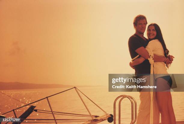 English actor Roger Moore as 007 with French actress Carole Bouquet as Melina Havelock on the set of the James Bond film 'For Your Eyes Only',...