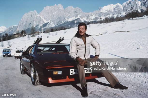 English actor Roger Moore poses as 007, with a Lotus Esprit Turbo, on the set of the James Bond film 'For Your Eyes Only', February 1981.