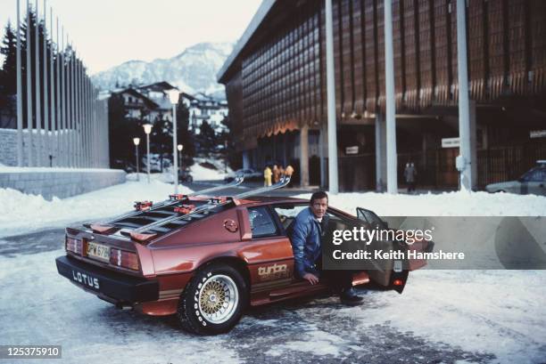 English actor Roger Moore poses as 007, with a Lotus Esprit Turbo, on the set of the James Bond film 'For Your Eyes Only' in Cortina d'Ampezzo,...