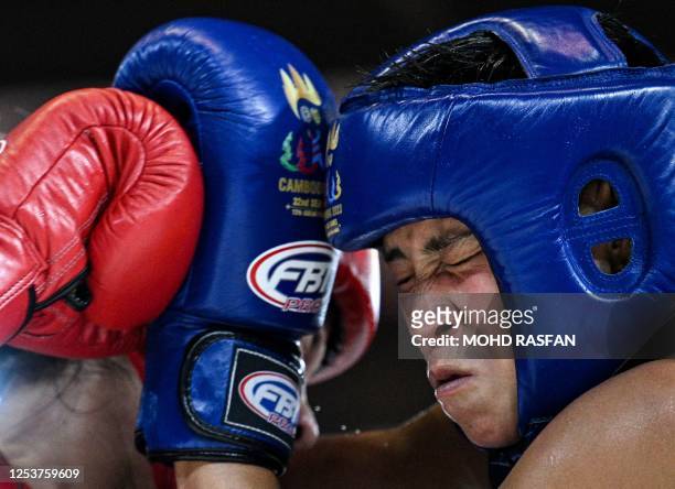 Cambodia's Moeuy Soeng and Vietnam's Thi Phuong Thuy Trieu compete in the women's 51kg kun khmer fight during the 32nd Southeast Asian Games in Phnom...