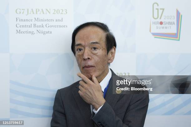 Kazuo Ueda, governor of the Bank of Japan , pauses while speaking to members of the media on the sidelines of the Group of Seven finance ministers...