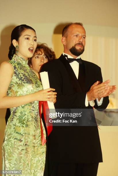 Gong Li and Bruce Willis attend the 47th Cannes film Festival in May 1994, in Cannes, France.