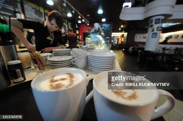 Barista creates portraits of Vladimir Putin with cinnamon and cocoa powder sprinkled on the foam of a cappuccino at a coffeehouse in Moscow, on...