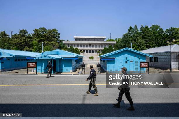 In this photo taken on May 9 South Korean soldiers walk at the truce village of Panmunjom in the Joint Security Area of the Demilitarized Zone...