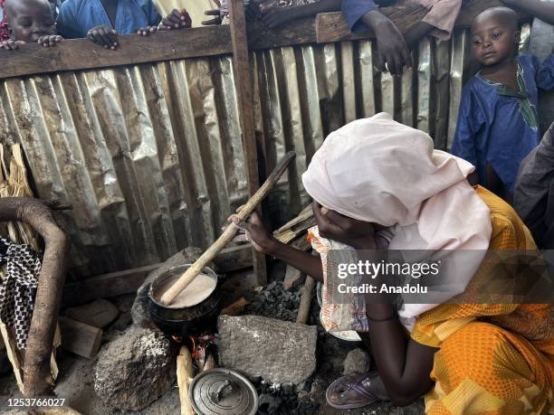 Woman cooks over the fire inside a makeshift tent at the Gwoza IDP Camp in Borno State, Nigeria on May 03, 2023. While the number of people displaced...