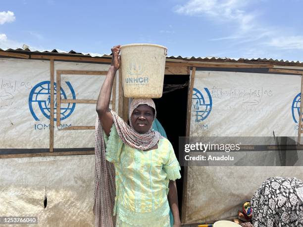 Woman carries bucket of clean water on her head at the Gwoza IDP Camp in Borno State, Nigeria on May 03, 2023. While the number of people displaced...